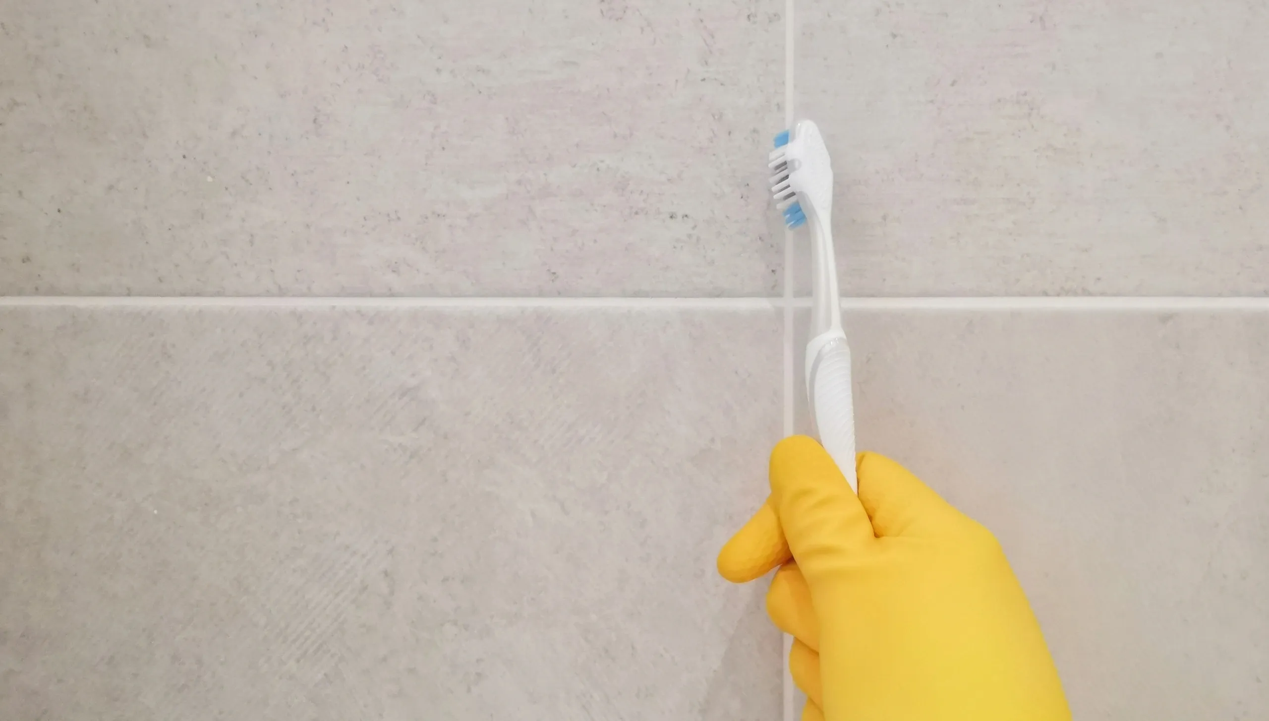 Tile and grout cleaning with a brush