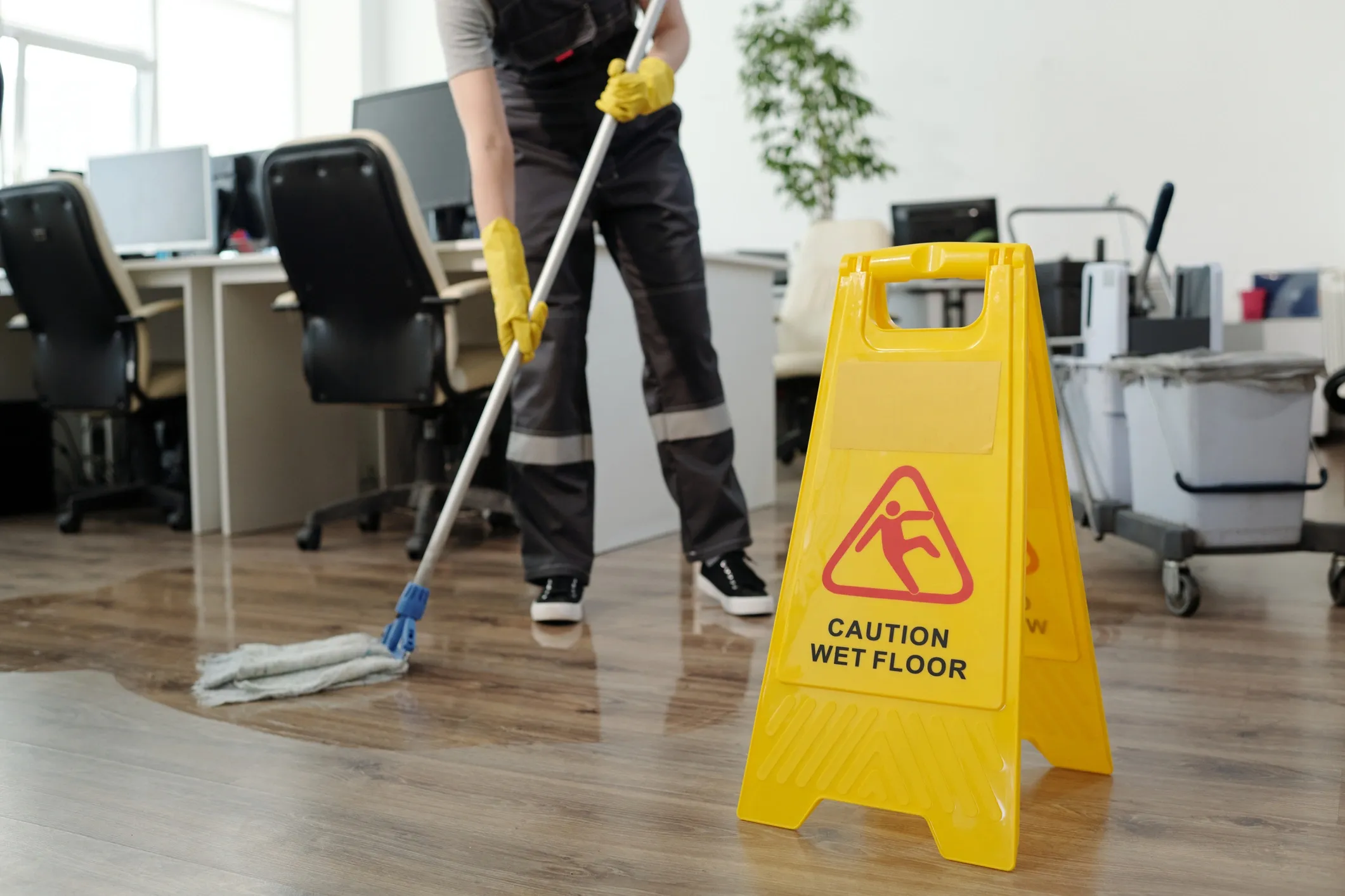 Professional cleaner working in a commercial space during a window and office cleaning service