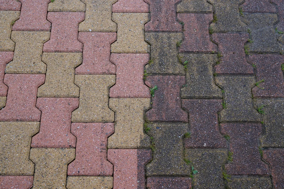 Before and after high pressure paver cleaning — moss and grime removed