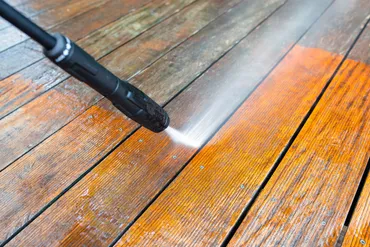 Pressure washer cleaning outdoor deck boards