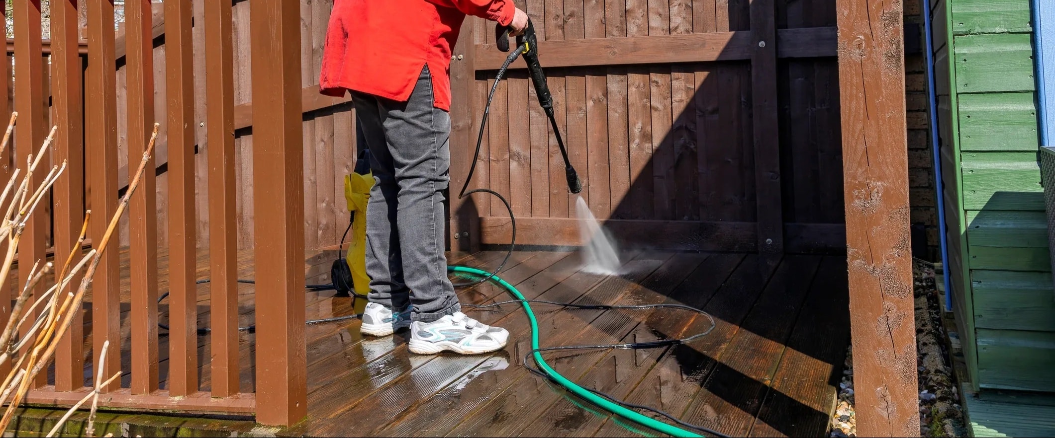 Pressure washing wooden deck boards at a Perth residential property