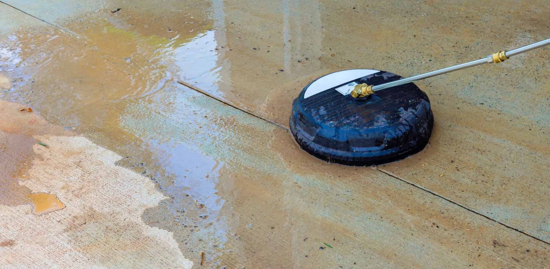 Pressure washer cleaning a concrete driveway at a Perth residential property